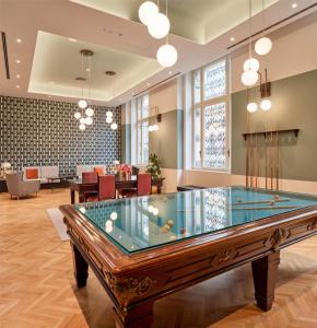 a pool table in the middle of a room at DoubleTree By Hilton Trieste in Trieste