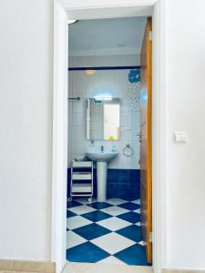 a blue and white bathroom with a sink and a mirror at Stunning Casa Nicole by Be Cherish in Pêra