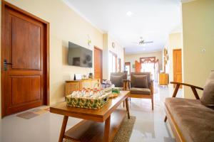 a living room with a couch and a table at Joglo Prambanan A4 in Bugisan