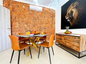 a dining room with a table and chairs and a painting of a lion at Luxury Condo in Top Complex with Ocean and Marina View by Be Cherish in Albufeira +42 photos