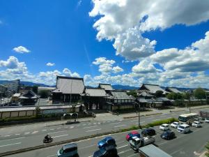 a street with cars parked on a road with buildings at Rest Collection GuestOne Kyoto in Kyoto +42 photos