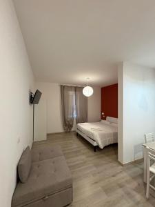 a bedroom with a bed and a couch in it at Da Peppino e Nicchella in Marina di Camerota +23 photos