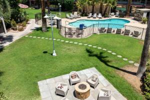 an overhead view of a pool with chairs and a table at Papago Scottsdale by Reside, Trademark Collection by Wyndham in Scottsdale