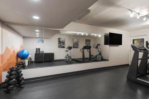 a room with a gym with exercise equipment and a television at Papago Scottsdale by Reside, Trademark Collection by Wyndham in Scottsdale +95 photos