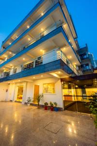 a large building with a balcony and a staircase at Hotel The Classic Inn Noida sector 70 in Noida