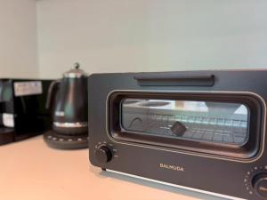 a black toaster oven sitting on top of a counter at Yura-Shirabe in Karuizawa