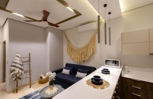 a kitchen and living room with a blue couch at Hideaway in Tulum Hotel Zone in Tulum