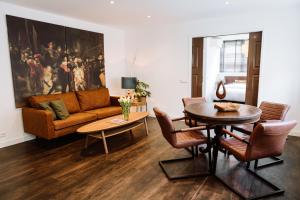 a living room with a table and a couch at Pension Montmaertre in Zierikzee +13 photos