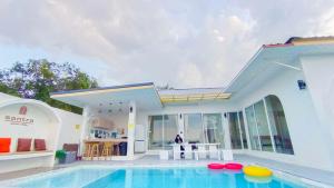 a villa with a swimming pool and a house at Santra Pool Villa in Pattani