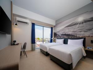 Cama o camas de una habitación en Aston Inn Lumajang - East Java