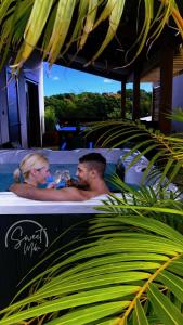 a man and a woman in a bath tub at Sweet Moka in Sainte-Marie