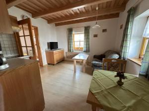 a living room with a couch and a table at Ferienhaus am Waldrand in Neukirchen vorm Wald