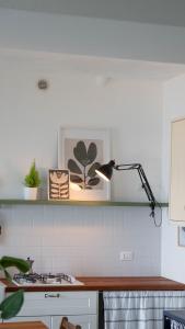 a kitchen with a stove and a lamp on a counter at Casa Lodovica con Vista Mare Mozzafiato in Riomaggiore +14 photos