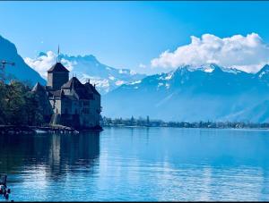a building on an island in the middle of a lake at Montreux Stunning 2 Bedroom Apartment Lake Geneva in Montreux