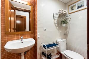 a bathroom with a sink and a toilet and a mirror at Home Trinidad in Málaga +12 photos