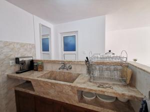 a bathroom with a large sink and a mirror at Studio Garden City Center Pomorie in Pomorie