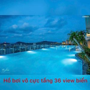 a large swimming pool with blue water at night at căn hộ the sóng 3 phòng ngủ in Vung Tau