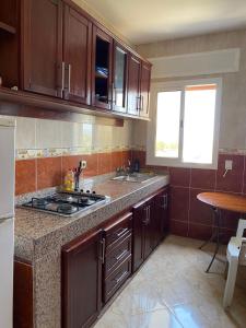 a kitchen with wooden cabinets and a counter top at Appartements Armonía Sea View in Briech +22 photos