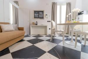 a living room with a black and white checkered floor at TEATRUM LOFT Teatro Galli -Jacuzzi in camera in Rimini +27 photos