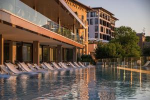 a swimming pool with lounge chairs in a building at Amadria Park Grand Hotel 4 Opatijska Cvijeta in Opatija