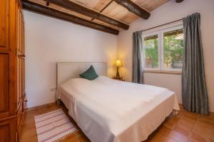 a bedroom with a white bed and a window at Individual Guesthouse Mallorca in Son Macia +21 photos