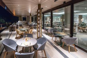a restaurant with tables and chairs and windows at Amadria Park Grand Hotel 4 Opatijska Cvijeta in Opatija