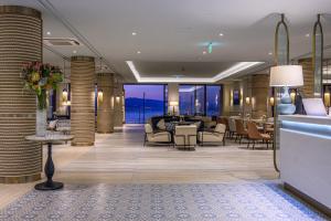 a lobby of a hotel with tables and chairs at Amadria Park Grand Hotel 4 Opatijska Cvijeta in Opatija