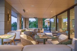 a restaurant with tables and chairs and windows at Amadria Park Grand Hotel 4 Opatijska Cvijeta in Opatija