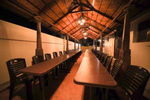 a long row of tables and chairs in a train station at M3 Homestay in Madurai