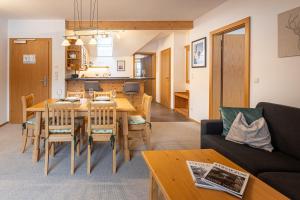 a living room and dining room with a table and chairs at Apparthaus Sonnenberg in Haus im Ennstal