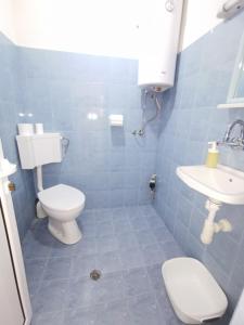 a bathroom with a toilet and a sink at Studio Garden City Center Pomorie in Pomorie +12 photos