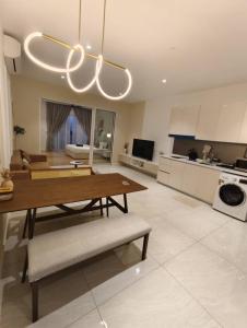 a living room with a table and a kitchen at QUILL RESIDENCE KUALA LUMPUR CITY By AZMILA EMPIRE in Kuala Lumpur