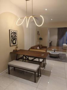 a living room with a table and a couch at QUILL RESIDENCE KUALA LUMPUR CITY By AZMILA EMPIRE in Kuala Lumpur +16 photos