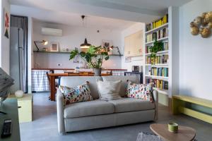 a living room with a couch and a dining room at Casa Lodovica con Vista Mare Mozzafiato in Riomaggiore