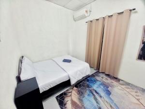 a small bedroom with a bed and a glass floor at Perhentian Besut Homestay in Kuala Besut