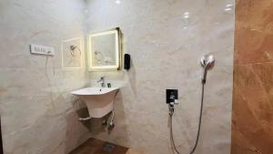 a bathroom with a sink and a shower at THE COMFORT Inn in Faizābād