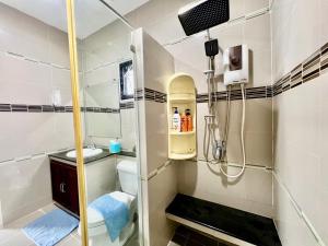 a bathroom with a shower and a toilet at Intro townhome korat in Ban Kao