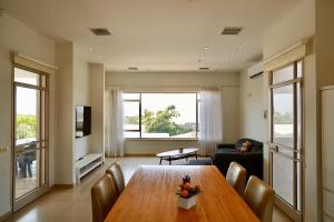 a living room with a table and a couch at פרדייז ריזורט in Had Nes