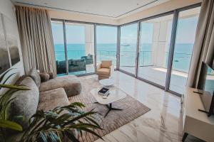 a living room with a couch and a table at 2 Bed with Sea Views in Trilogy, Limassol Seafront in Limassol +118 photos