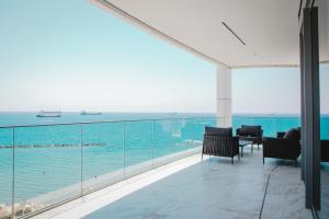a balcony with a view of the ocean at 2 Bed with Sea Views in Trilogy, Limassol Seafront in Limassol