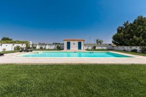a swimming pool in the middle of a yard at Il Gelsomino Bianco by BarbarHouse in Mottola