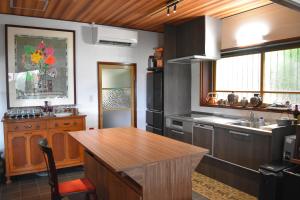 a kitchen with a wooden table and a sink at Atami Southern Wind　 熱海 南風楼(温泉付) in Atami +26 photos