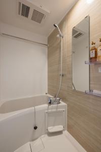 a bathroom with a sink and a mirror at self-check in 67HOTEL AKIHABARA in Tokyo
