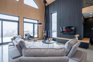 a living room with two couches and a tv at Panoramic View - Spa - L'Espace-temps in Saint Come +60 photos