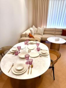 a living room with a white table with plates and glasses at Seabreeze in Baku