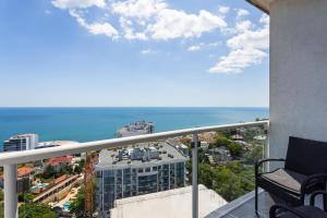 a balcony with a view of a city and the ocean at Sea Pearl 1Line in Odesa