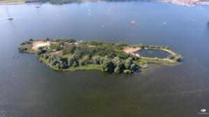an island in the middle of a large body of water at CampSpirit in Biddinghuizen