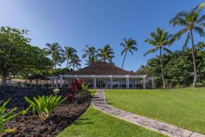a resort with palm trees in the background at Mauna Lani Point stunning sunset and ocean views in Waikoloa