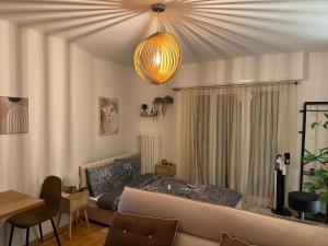 a living room with a couch and a chandelier at Centre Lausanne in Lausanne