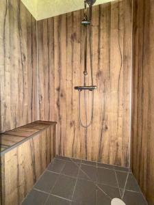 a bathroom with a shower in a wooden wall at Ferme Bressane - 4 chambres in Saint-Étienne-du-Bois +21 photos